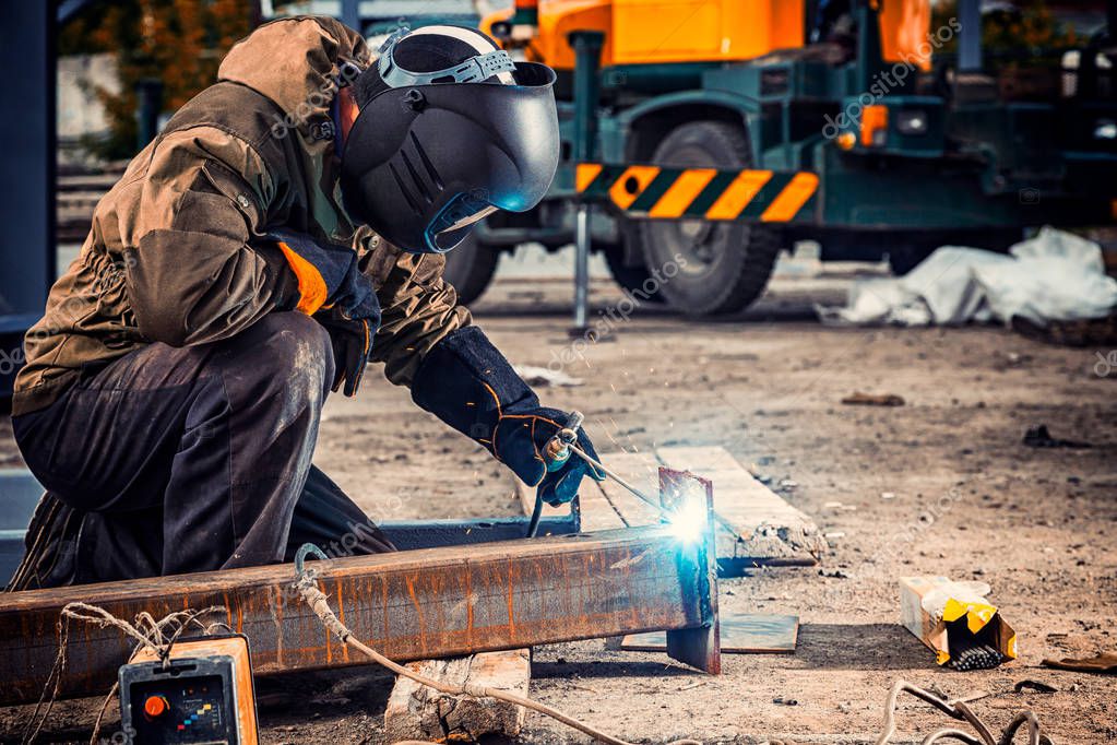 depositphotos 209995272 stock photo young man welder brown uniform